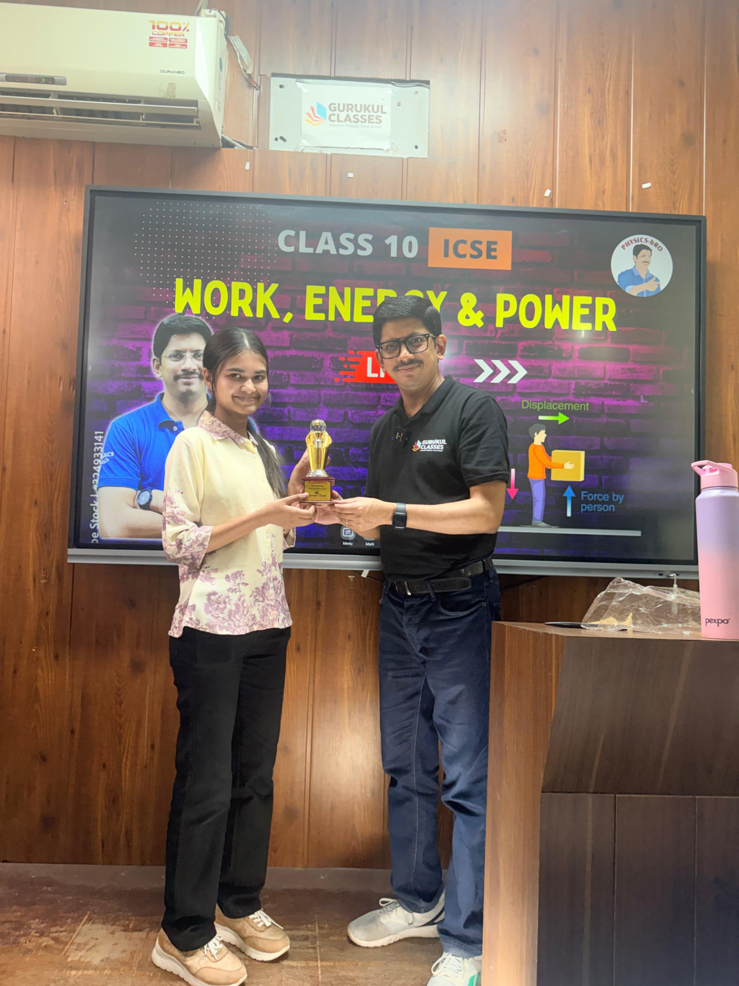 Student awarded a trophy during a Class 10 ICSE Work, Energy and Power lecture