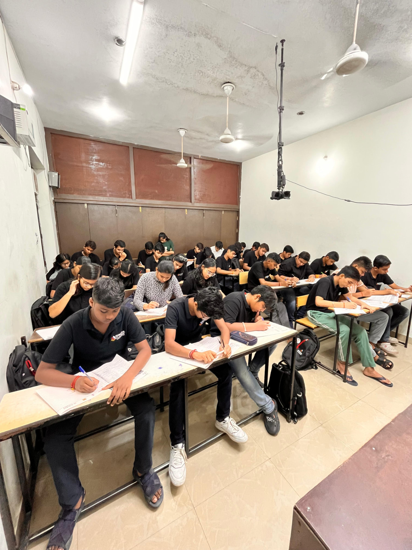 Full classroom of Gurukul Classes students during a test session