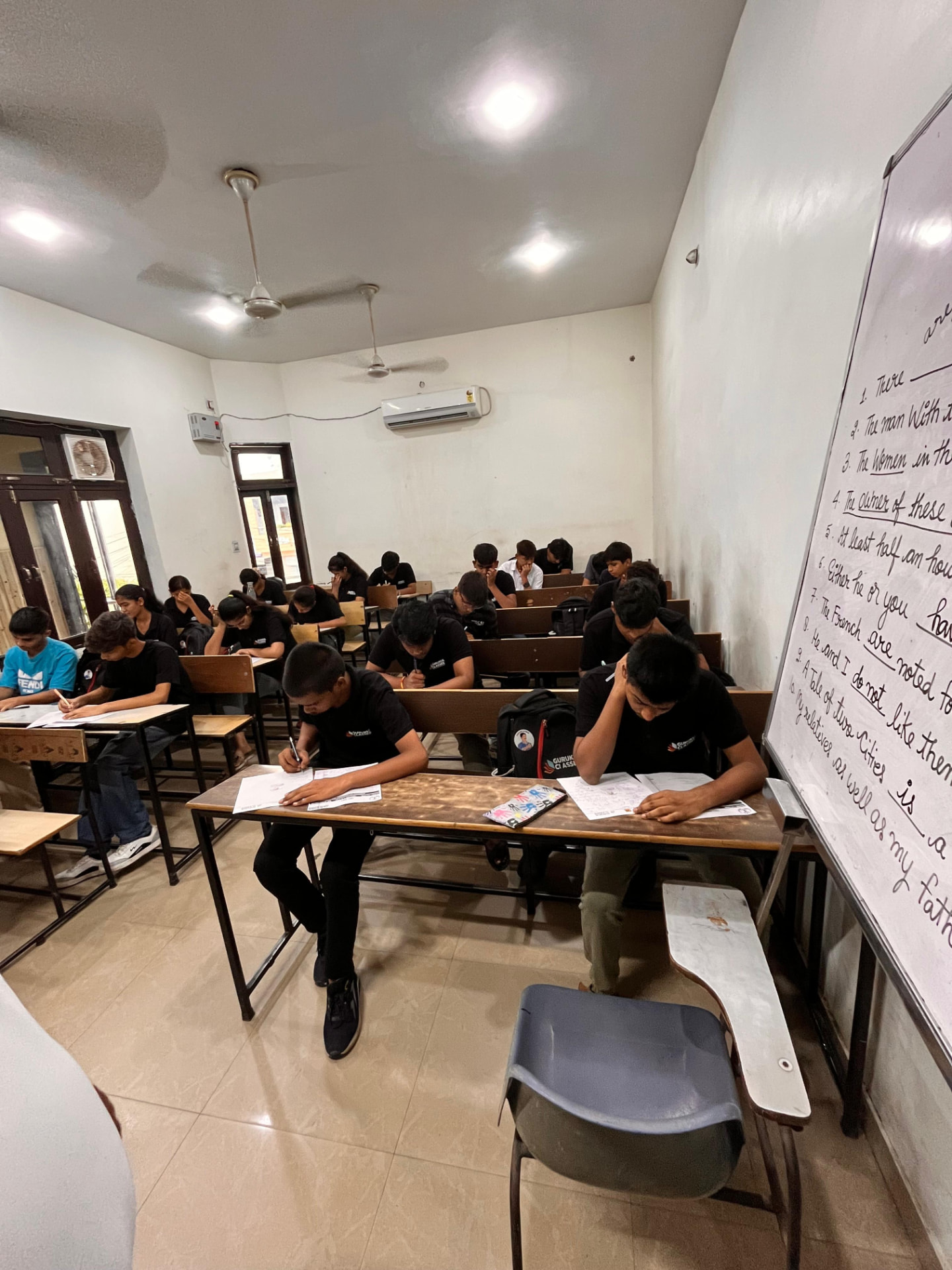 Gurukul Classes students solving grammar exercises on the whiteboard test