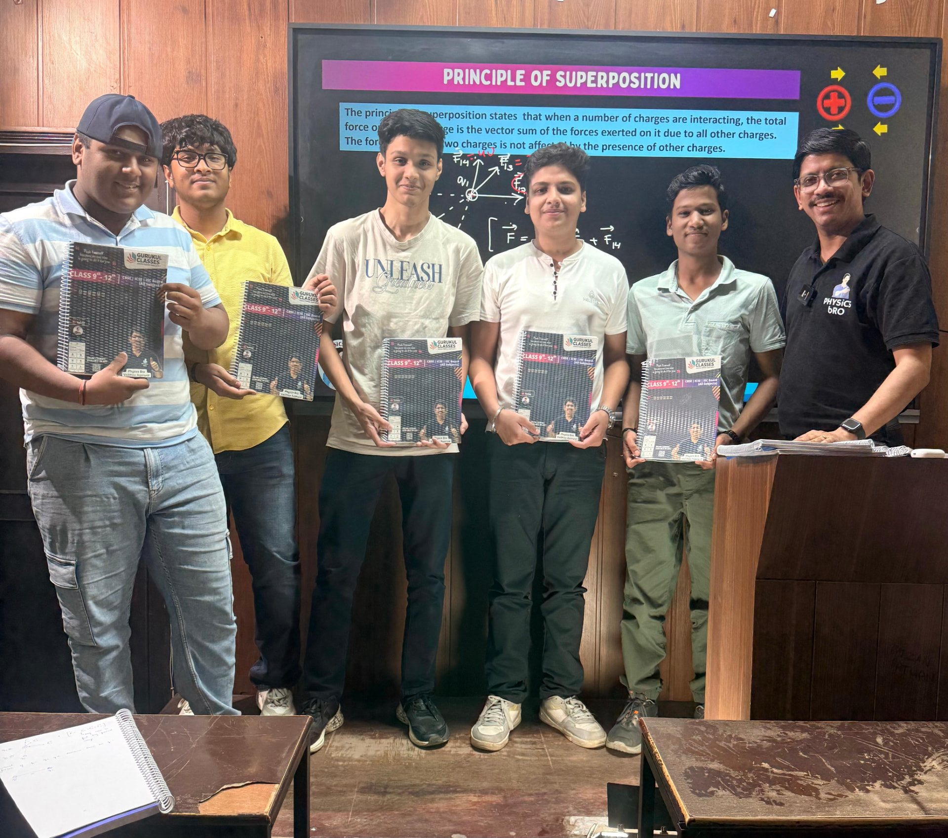 Students with Class 9-12 Gurukul Classes booklets during a Physics superposition lecture