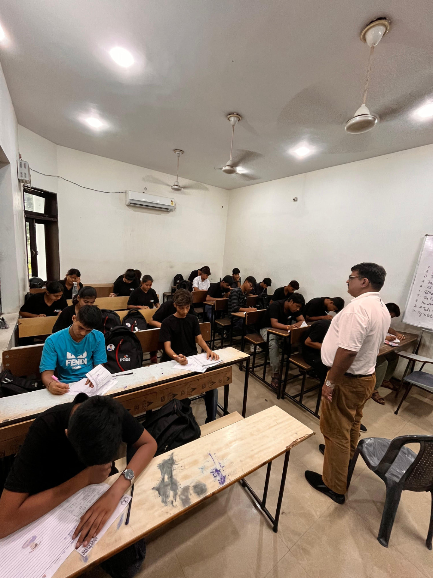 Faculty member invigilating a test at Gurukul Classes