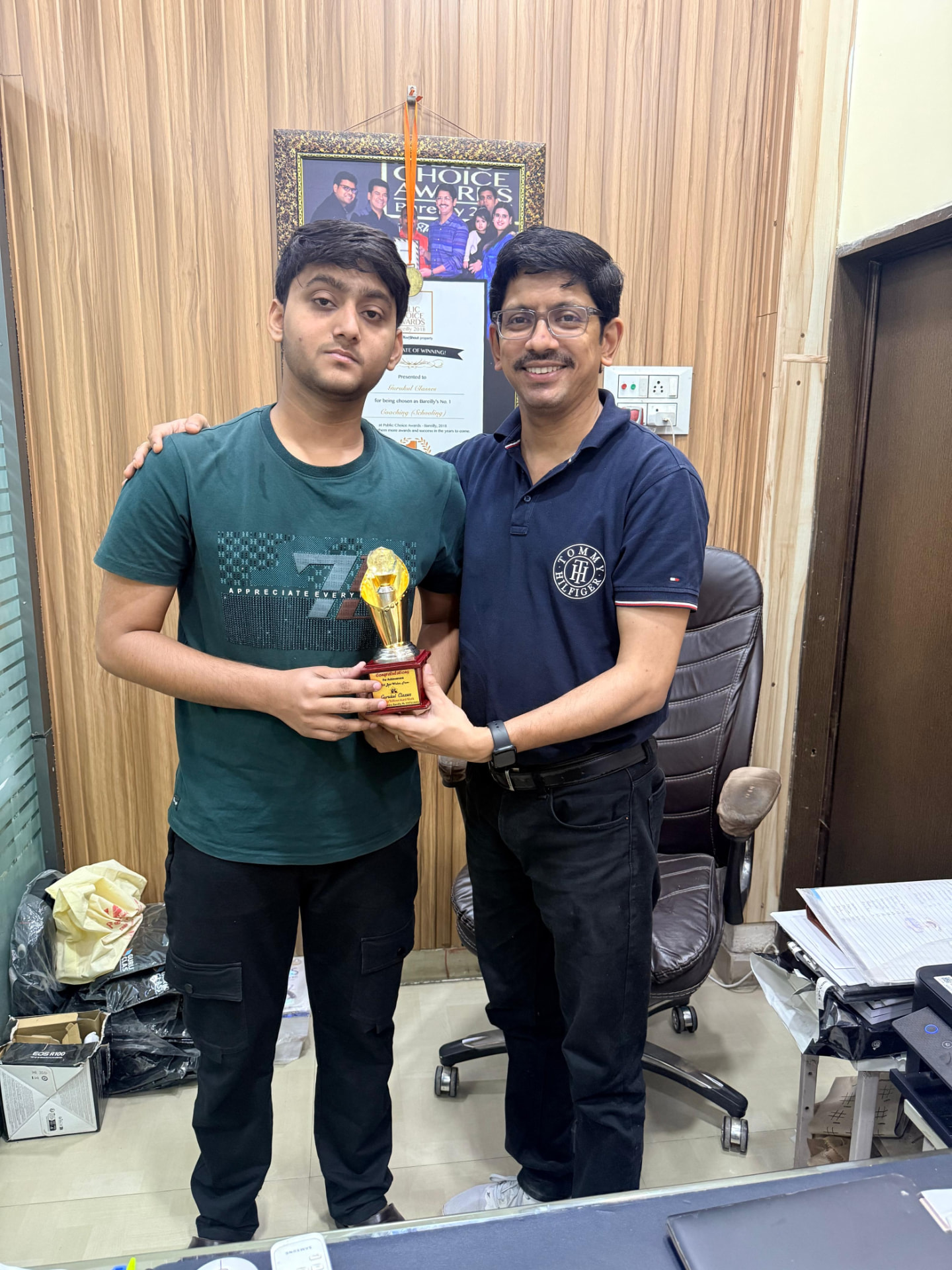 Achiever felicitated with a Gurukul Classes trophy at the institute office
