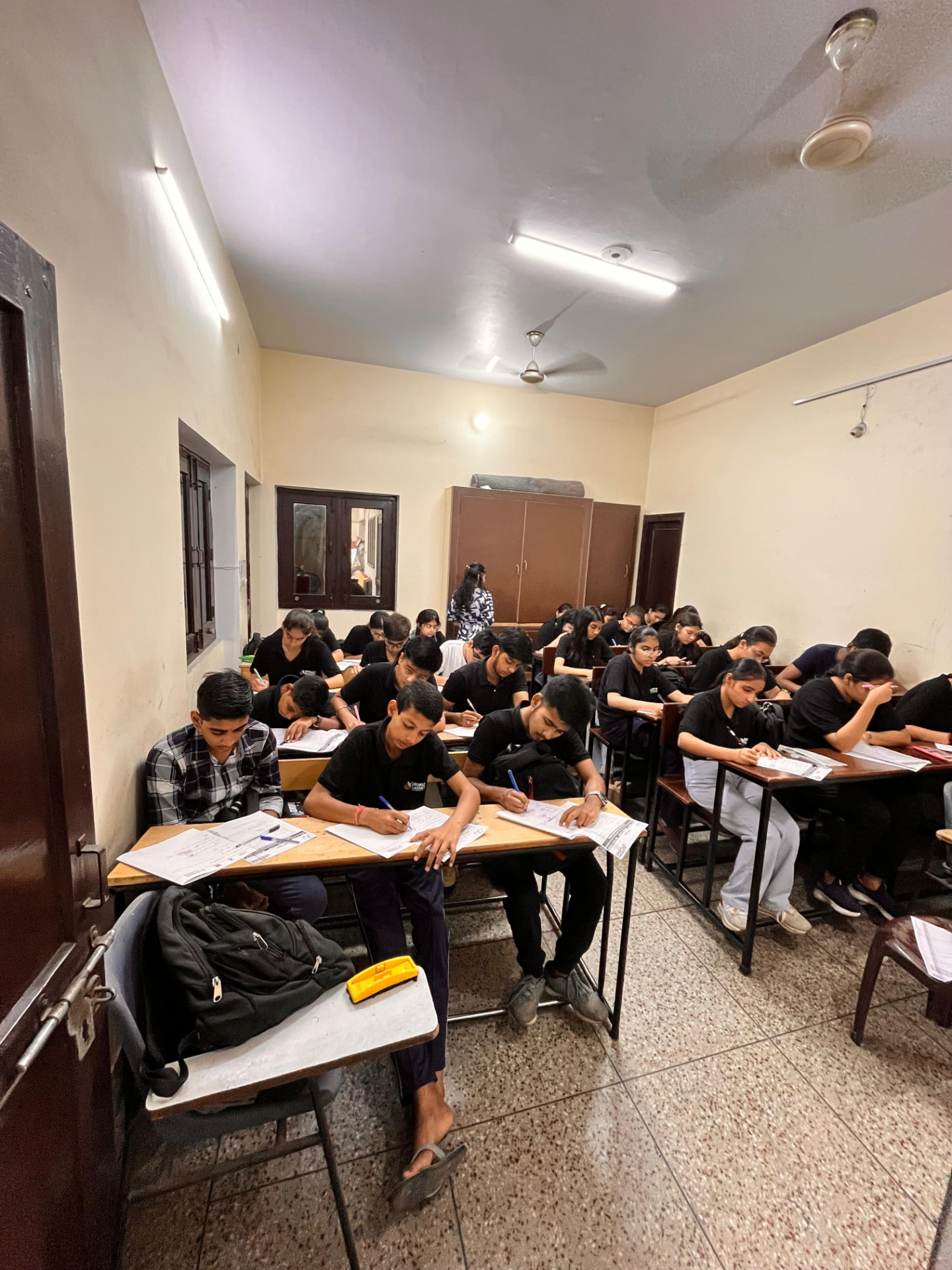 Students writing a chapter-wise test in a Gurukul Classes classroom