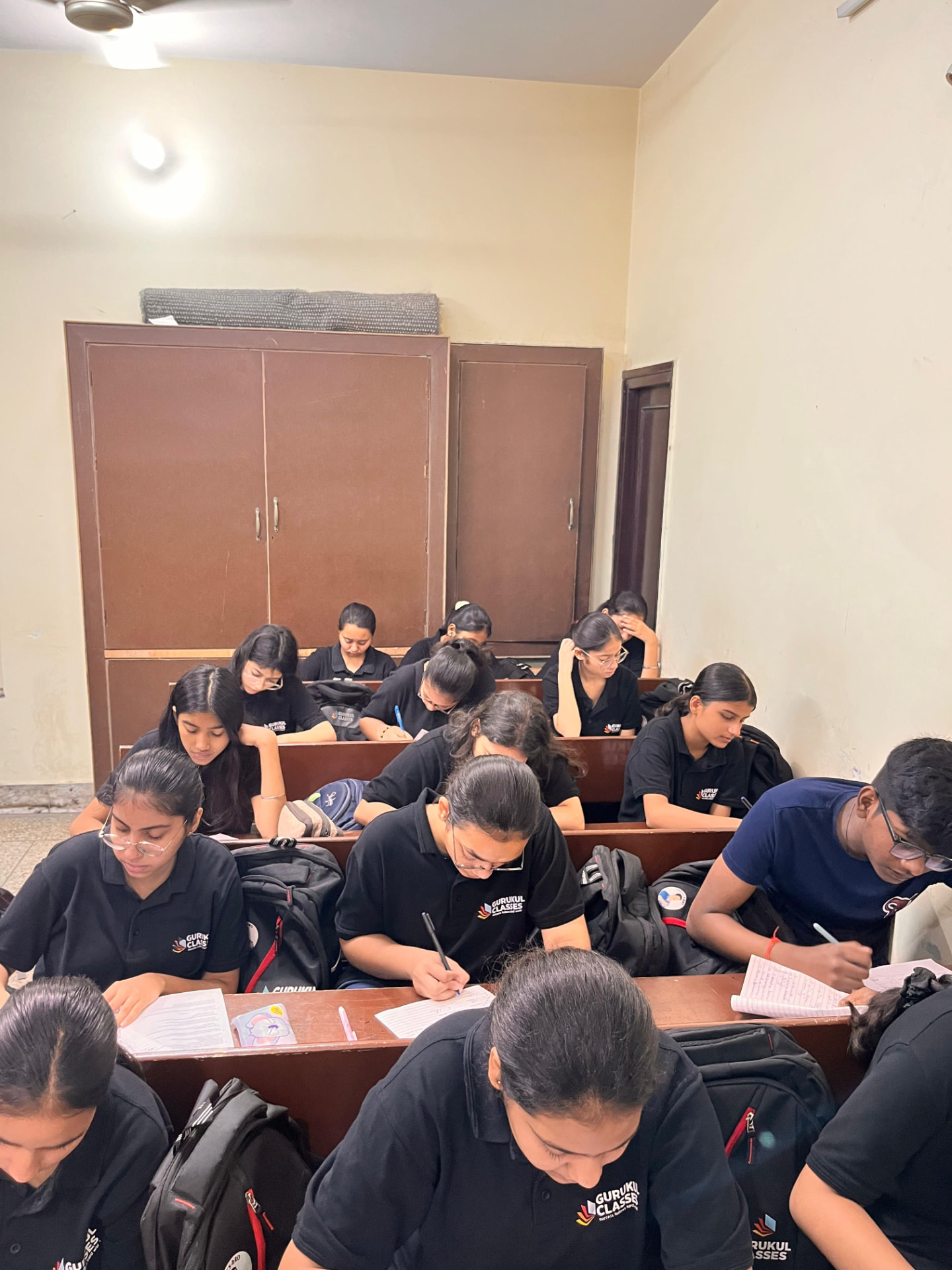 Gurukul Classes batch in uniform attempting a written test